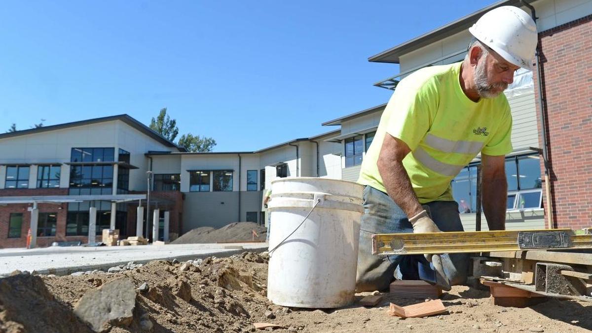 Wayne Pate of S& S Concrete sets up concrete forms outside the new Fisher Elementary School Tuesday, Aug. 22, 2017, in Lynden. During the first quarter of 2017, Whatcom County posted a big increase in construction jobs, which tends to pay a higher wage than many industries.