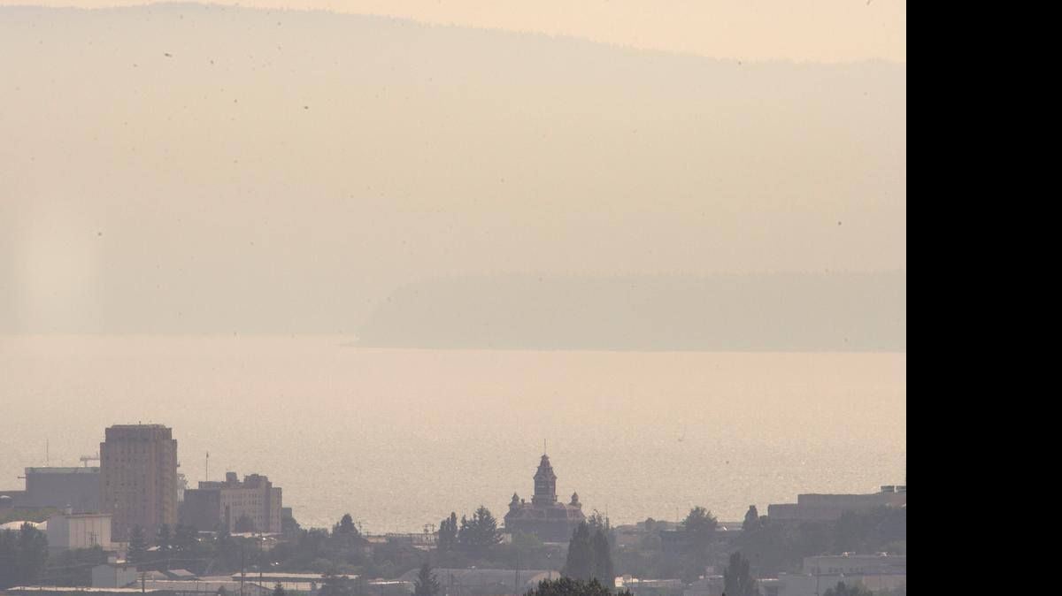 
Haze from British Columbia forest fires obscures the view of downtown Bellingham from Chandler Parkway on Monday afternoon, July 6, 2015.
