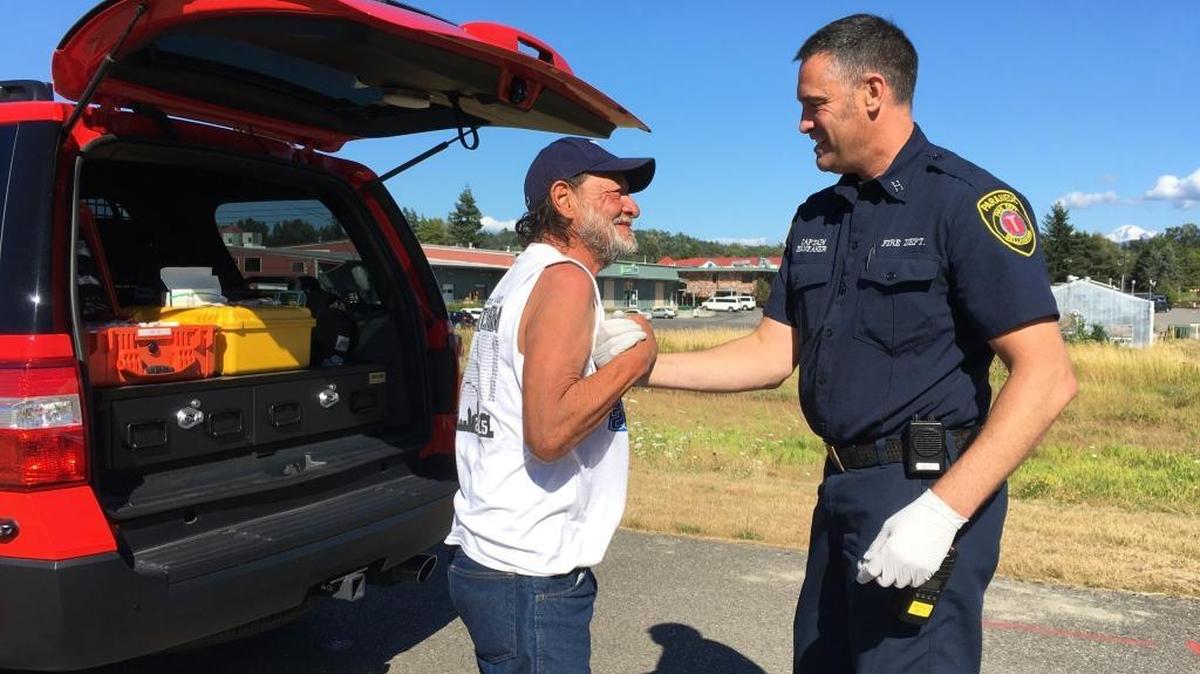 Carlos Abitia, left, greets Bellingham Fire Capt. Jeff Brubaker in September near a vacant lot where Abitia, who's homeless and living outdoors, often sleeps. The Whatcom County Council has formed an 11-member Homeless Strategies Workgroup made up of representatives from city and county government, social service groups that help the homeless, and organizations that represent businesses.