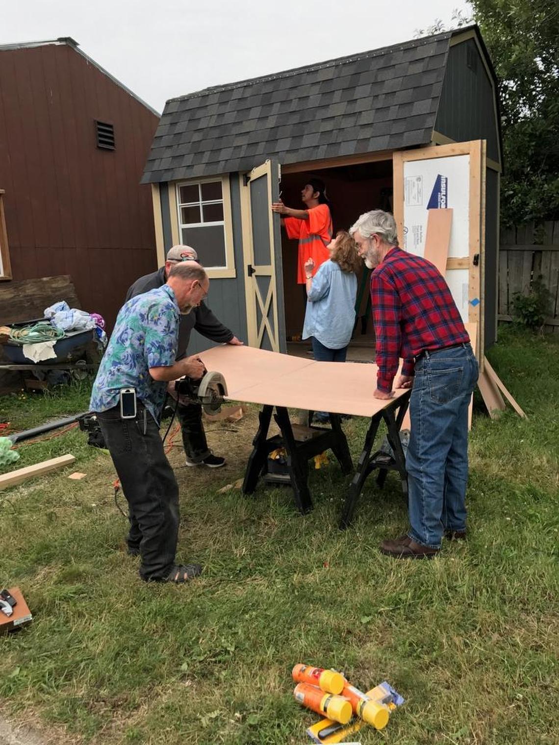 Volunteers worked most of the day Saturday to place electrical wiring, siding and vinyl flooring in the home.