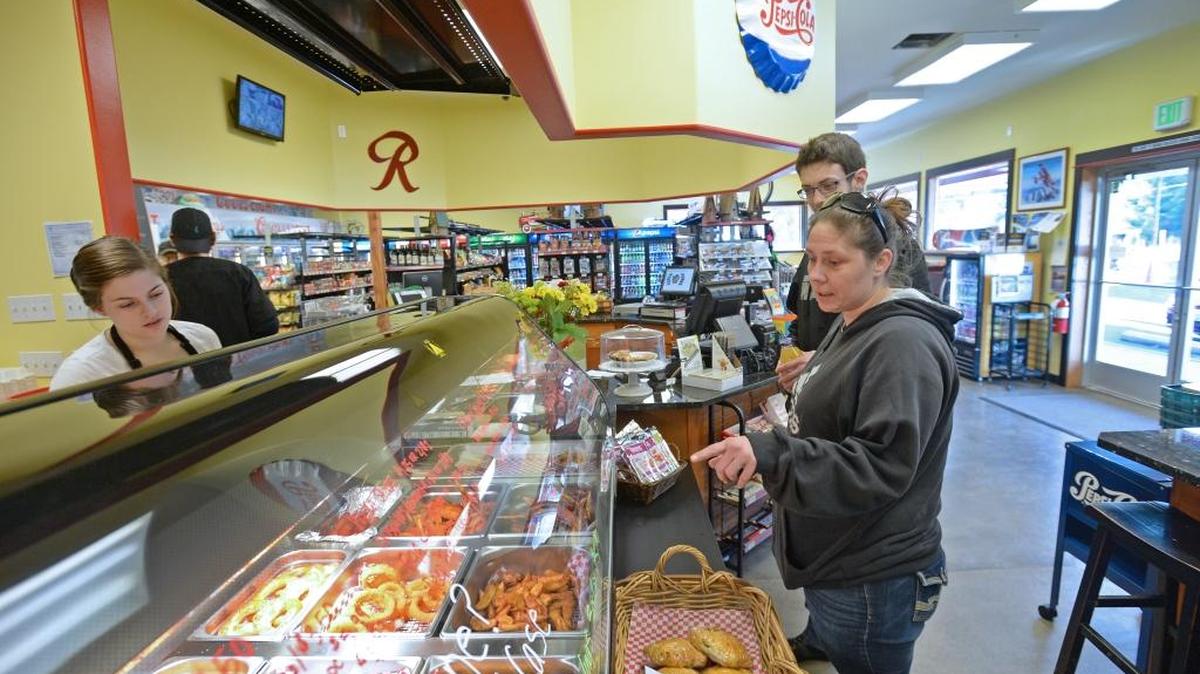 Alison Hubert, left, helps Wendy Simmonds and Thomas Paine buy some lunch at the Welcome Grocery Store on Mount Baker Highway, east of Deming, on Tuesday Feb. 9, 2016. The store opened Jan. 13, and a grand opening is scheduled for Feb. 19.
