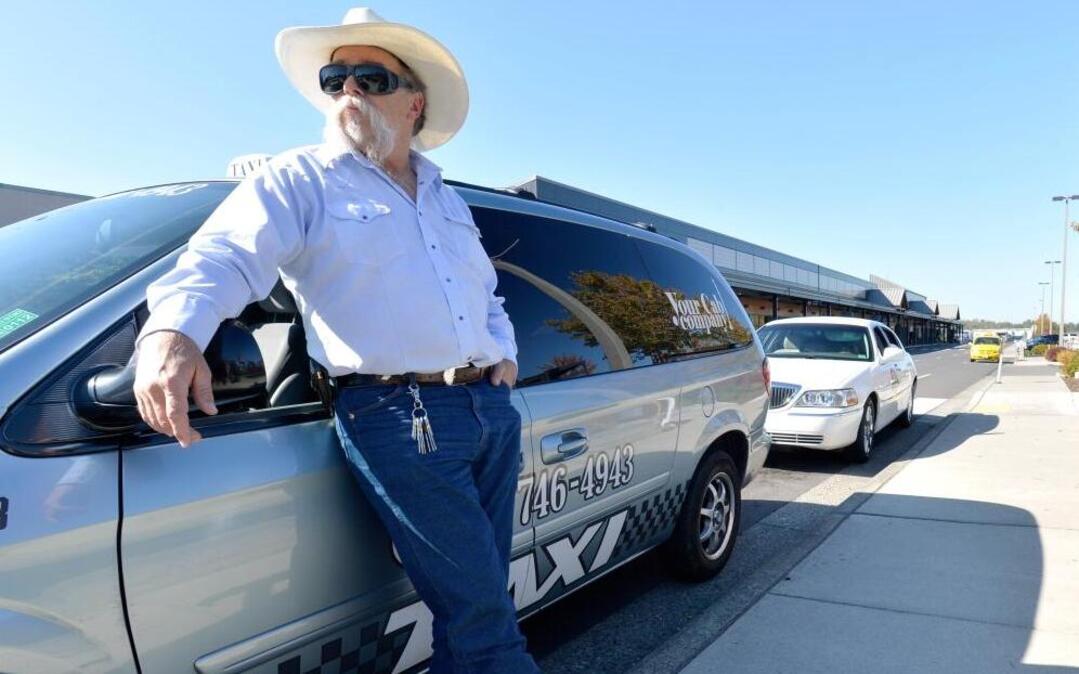 
Mark Metzler, co-owner of Your Cab Company, waits for fares at Bellingham International Airport on Tuesday, Sept. 29, 2015. Uber, the ride-sharing company, plans to start up in Bellingham and would be competing with Metzler and other cab companies for customers.
