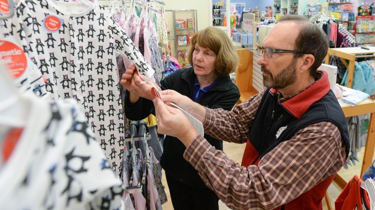 Janet and Mike Hodgin mark down prices in preparation for a liquidation sale at their store, Kids Northwest, in downtown Bellingham Monday, Oct. 16, 2017.