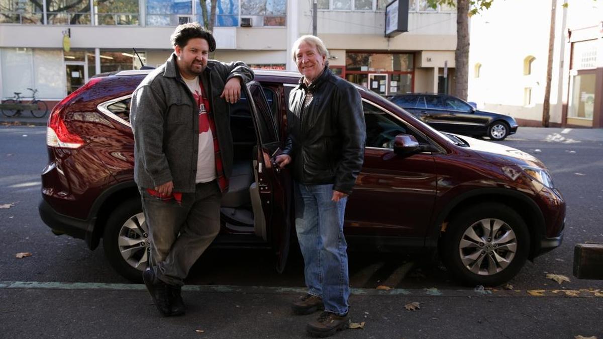 Austin Santiago, left, accepts a ride from Uber driver Buzz Steger at the Wild Buffalo in downtown Bellingham. The ride-sharing service company began operating in Bellingham on Nov. 12, 2015.