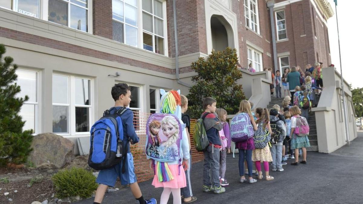 Students arrive for the first day of school at Lowell Elementary School on Aug. 26, 2015. Bellingham school officials are considering an earlier start time for elementary students and a later start time for high school students.