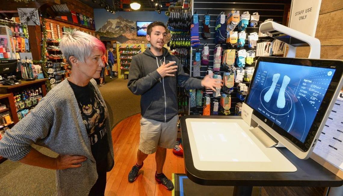 Customer Debbie Day, left, looks at a diagram of her feet while employee Chris Lantz explains how the new Superfeet FitStation works at Fairhaven Runners & Walkers store Thursday, July 27, 2017.