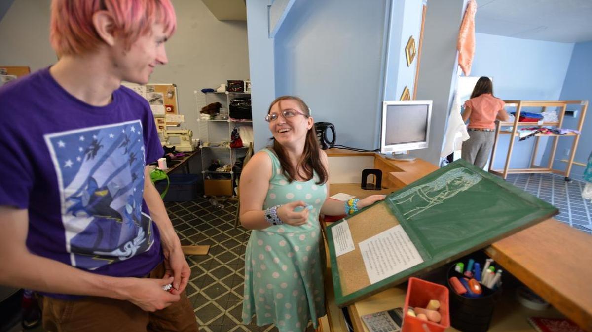 
Joshua Gage, left, admires Shania Neet’s chalk drawing at the Northwest Youth Services store, We Creations, at 929A N. State St., in Bellingham on July 29, 2014. Youths create screen-printed clothing and accessories for sale for the store. It’s one of the programs offered by Northwest Youth Services, which is working to add at least 20 new apartments to house its homeless clients.

