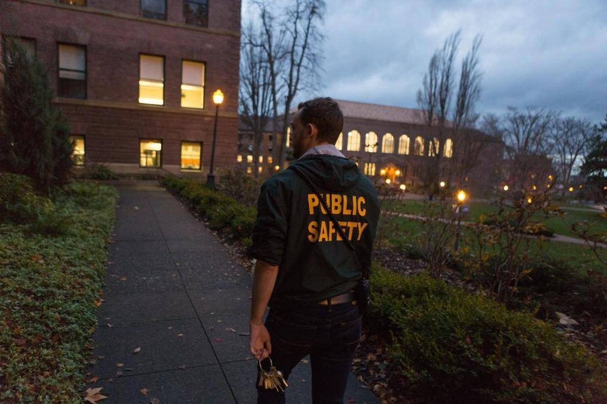 Western Washington University sophomore Sean Highley works as a "Green Coat" safety escort.
