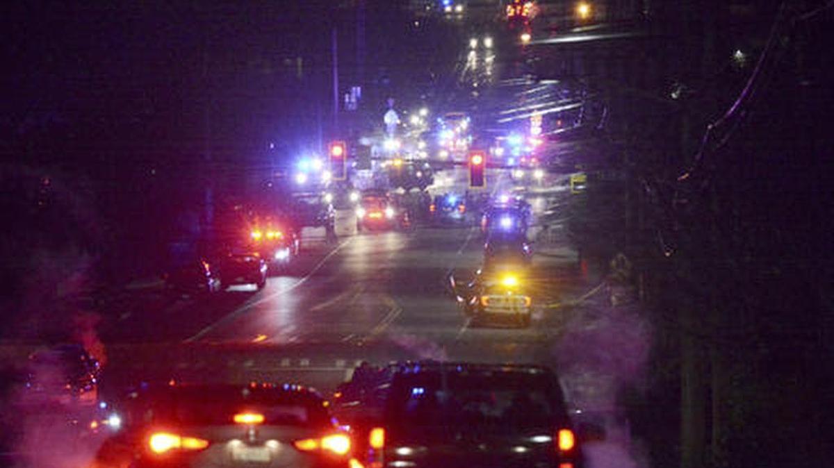 Law enforcement vehicles gather near Skagit Valley College in Mount Vernon, Wash., Thursday, Dec. 15, 2016. A Mount Vernon Police officer was shot and critically wounded by a suspect who was then barricaded in a Mount Vernon residence, authorities said.