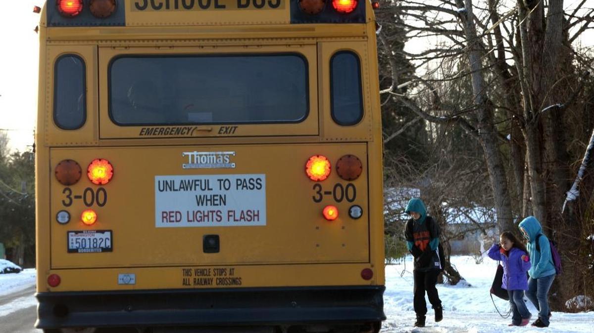 Blaine students board a school bus on Harborview Road in Birch Bay Wednesday morning, Dec. 14, 2016. Blaine schools started two hours later due to the wintry road conditions.