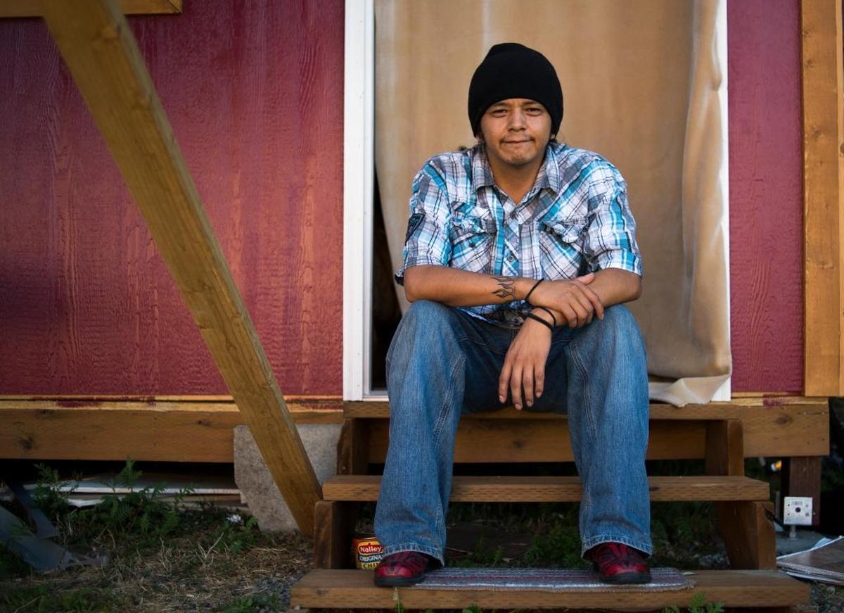 Jesse Solomon is pictured Thursday, Aug. 24 in front of the tiny home where he lives on the Lummi Reservation.