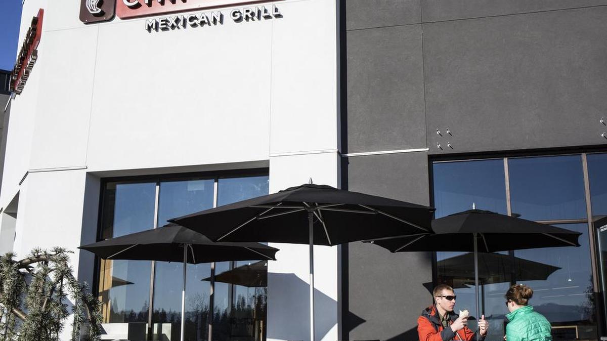 Dustin Kelley, left, and Tyler Chrisholm dig into food from Chipotle Mexican Grill during the restaurant's grand opening Saturday, Nov. 15, 2014 in Bellis Fair Mall.