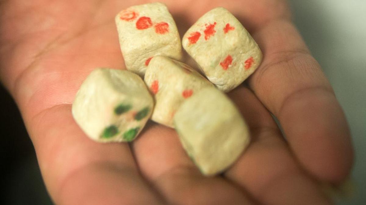 
An inmate shows playing dice made from pieces of a Whatcom County Jail cell wall on Thursday, July 30, in Bellingham.
