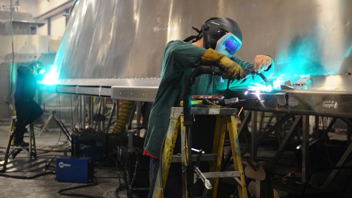 Welders Morgan Simpson, left, and Steve Leblanc tack together rub rails on a ferry to be delivered to a customer in New York in October at All American Marine on April 14, 2010. Rub rails help prevent the ferry from getting damaged if it bumps into a dock.