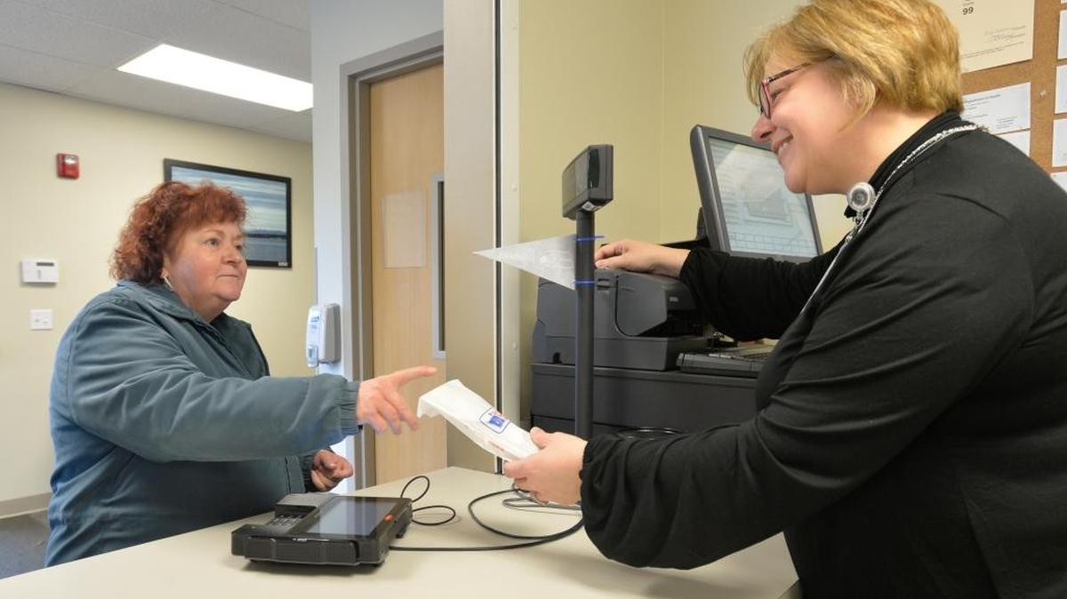 Customer Sherryl Cornish, left, gets her prescriptions from pharmacy technician Brenda Dubuc at the Unity Care NW pharmacy Tuesday morning, Nov. 24, 2015, in Bellingham. Part of the money raised during the Extend-a-Hand campaign goes to help people pay for their prescriptions at Unity Care.