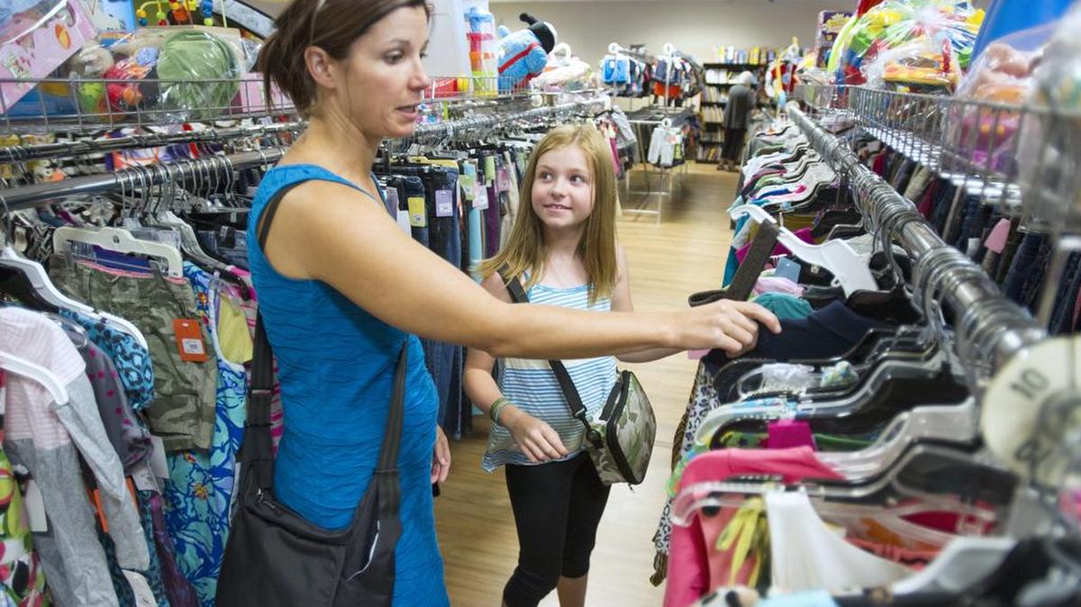 Sarah DesRosiers and her daughter Navah DesRosiers, 10, look at clothes at Wee Ones Reruns Thursday, July 16, 2015, in Bellingham. The consignment store near Trader Joe's has been in business 30 years.