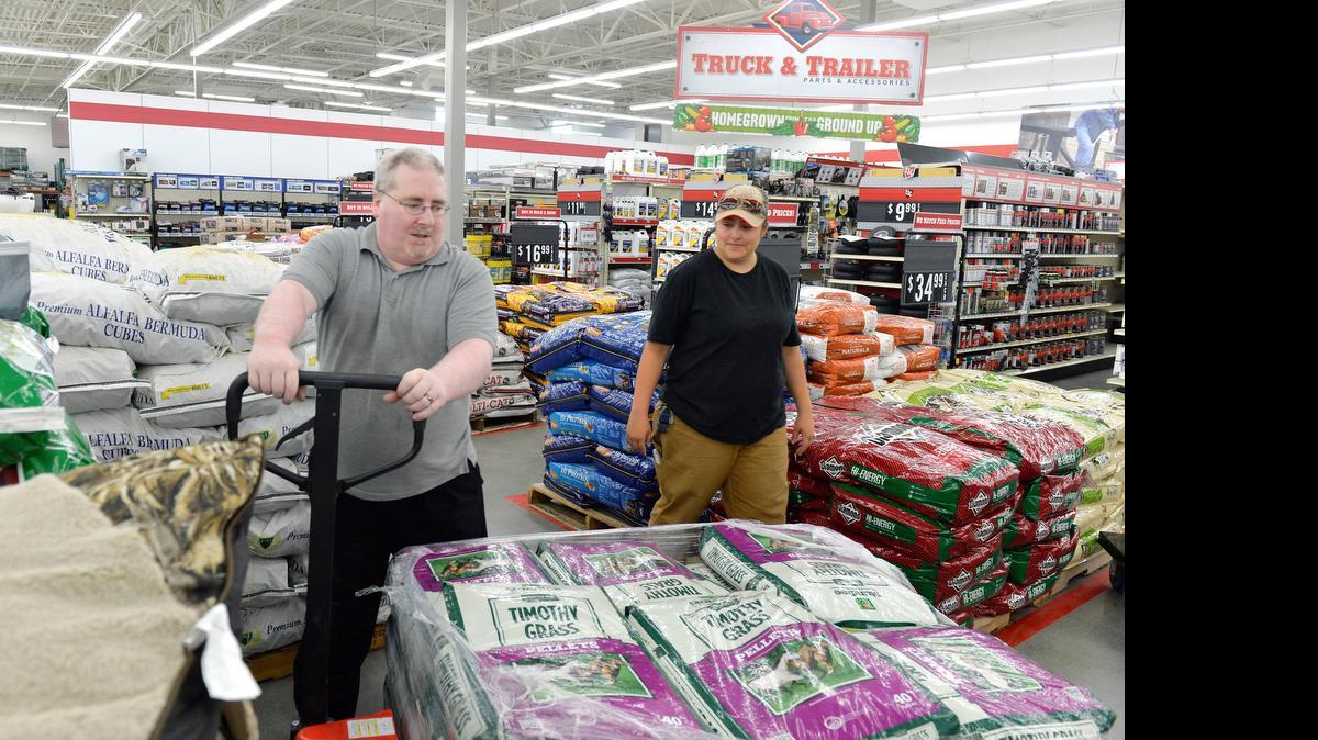 
Employees Scott Edwards and Jessica Pedraza move pallets of feed at the new Tractor Supply Co. store on Front Street in Lynden on Monday afternoon, July 27, 2015. The new store opens at 8 a.m. Saturday, Aug 1.
