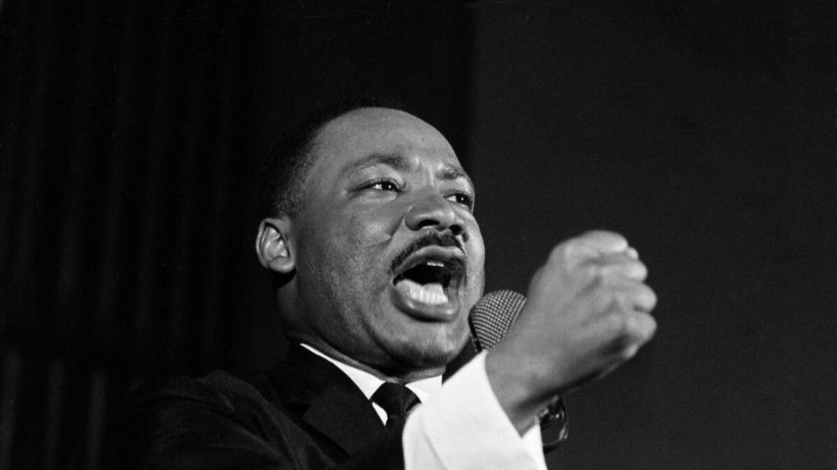 Dr. Martin Luther King Jr. shakes his fist during a speech in Selma, Ala., Feb. 12, 1965. King was engaged in a battle with Sheriff Jim Clark over voting rights and voter registration in Selma.