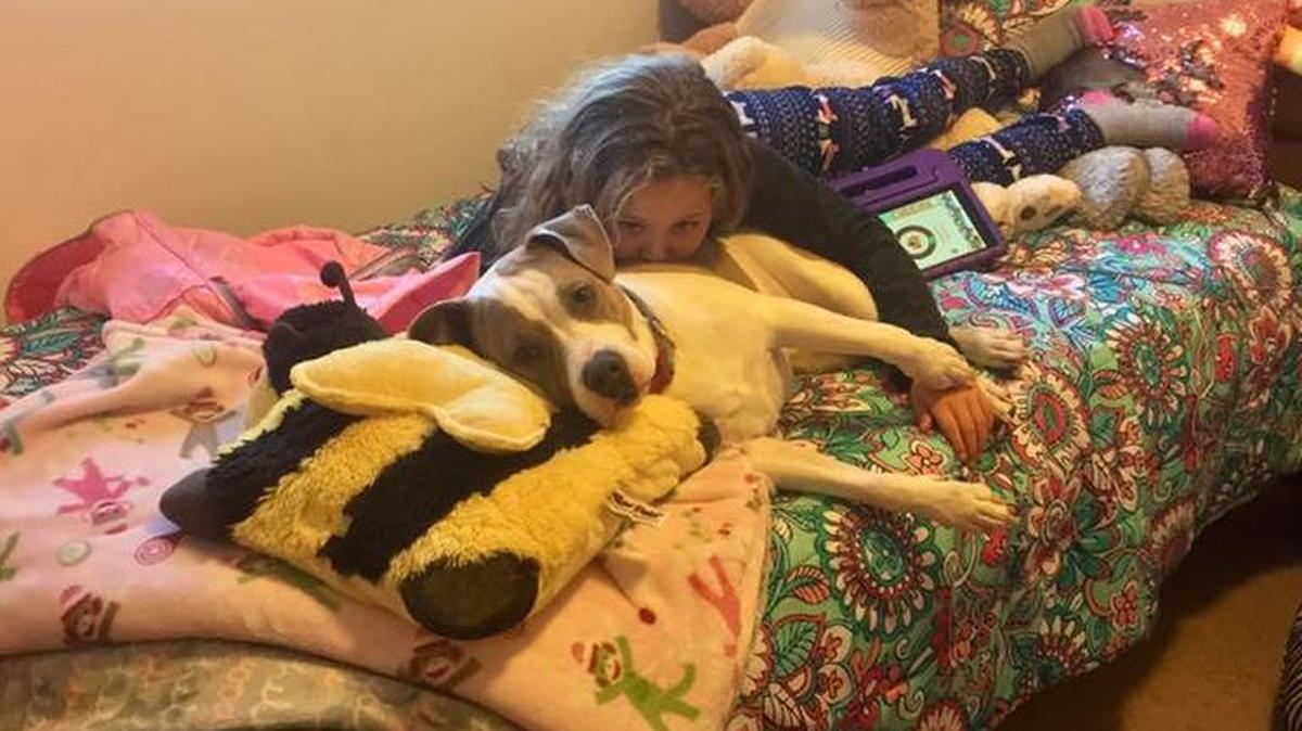 Nona and Stella relax on her bed at her uncle and aunt’s house.