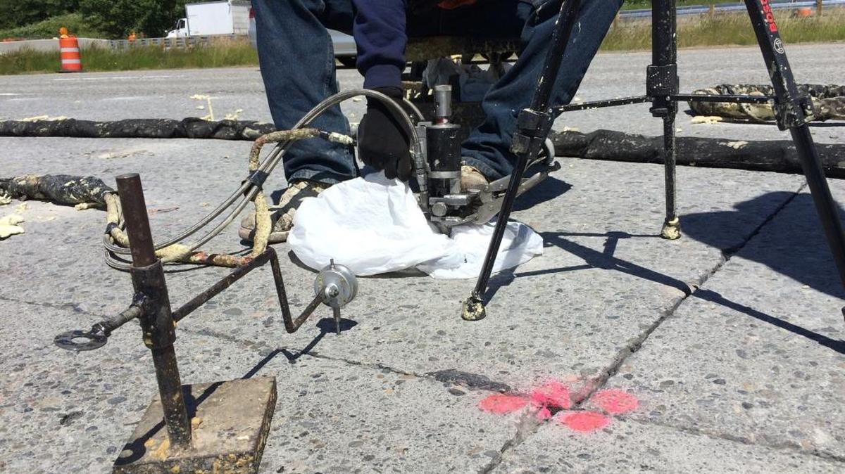 A worker with the Washington state Department of Transportation pumps a polymer into holes drilled into a concrete bridge deck on southbound Interstate 5 in Skagit County on June 21. The polymer helps lift and stabilize the bridge deck to make a smoother ride. Crews used a similar technique on southbound Guide Meridian near Lynden this week.