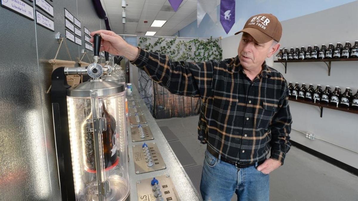 Sandy Petersen fills a growler of beer at the new Growlers Keep in Bakerview Square in Bellingham, Tuesday, Oct 31, 2017. The store has 48 beers on tap and uses carbon dioxide to keep the beer fresh in the growler.