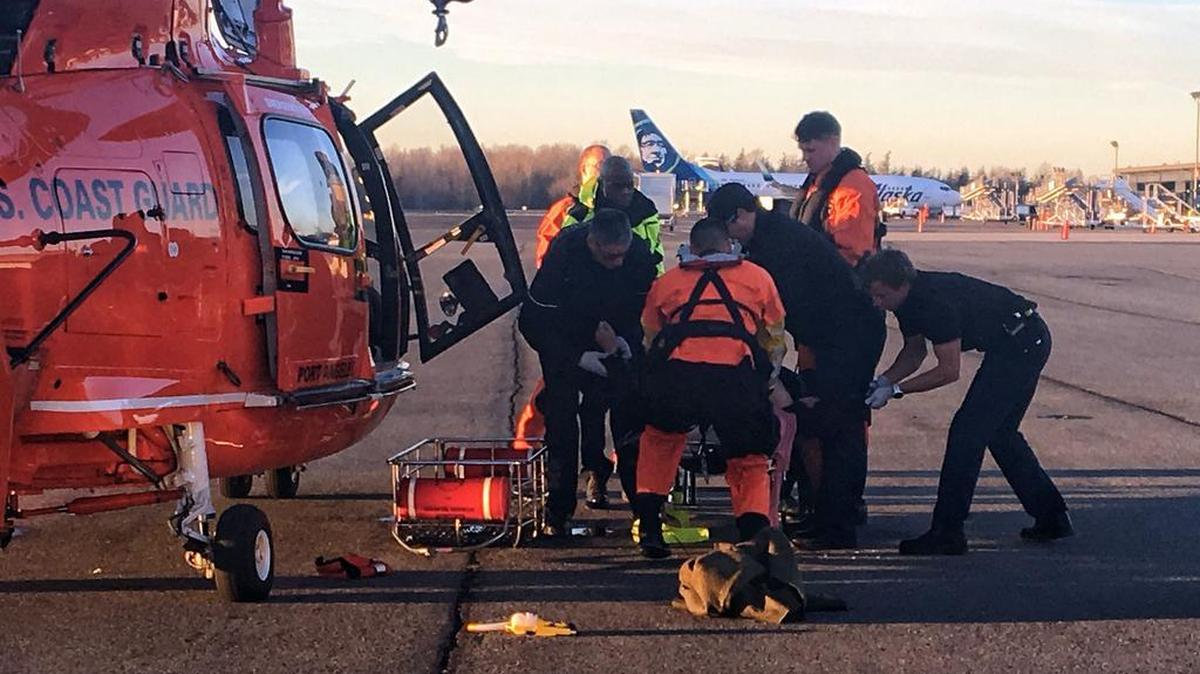 Bellingham Fire and Coast Guard crews tend to a man whose kayak capsized in Bellingham Bay on Wednesday, Dec. 20. The Coast Guard crew rescued the man and flew him to the waiting medic unit at Bellingham International Airport.