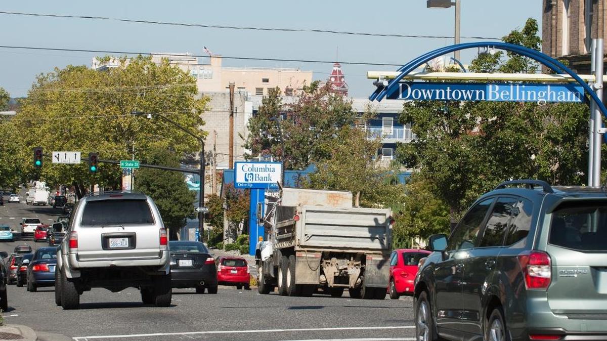 
Motorists drive down Holly Street on Friday, Sept. 11, in Bellingham, Wash. The city is considering several changes to Holly, including possibly replacing a traffic lane with a wide bike lane that also would have extra space between the lane and parked cars.
