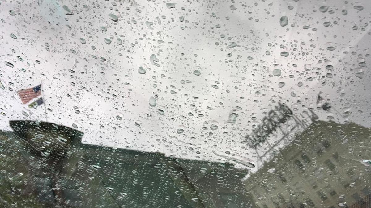 Raindrops gather on a car window reflecting the former Herald and Daylight buildings at the corner of State and Chestnut streets in downtown Bellingham in this file photo.