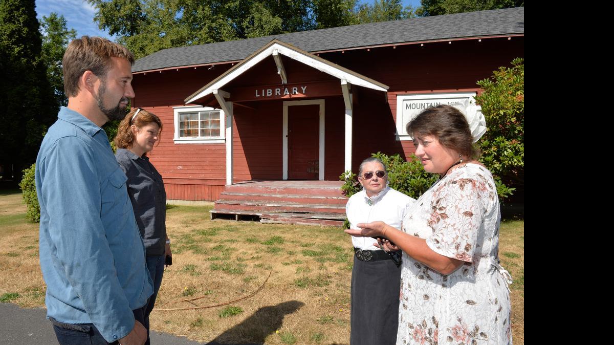 
Alcoa Intalco Works engineer Travis Linds, left, and public relations manager Raina Clark talk to Ferndale Heritage Society members Bonnie Wiesen and Linda Harkleroad on Thursday, June 25, 2015. Society members are raising money to move the 99-year-old West Mountain View School building and library from Intalco’s property to Pioneer Park in Ferndale.
