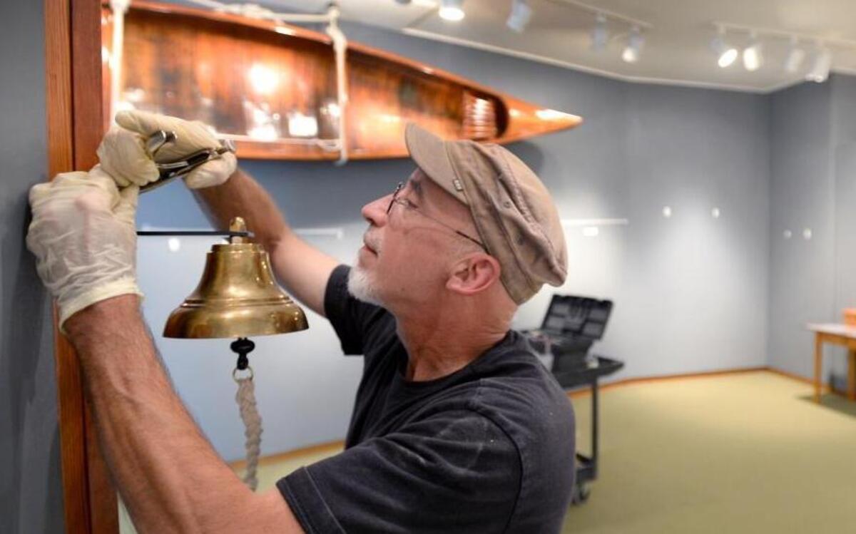 David Miller installs a ship’s bell in the new maritime history exhibit at Whatcom Museum’s Old City Hall building Monday, Aug. 1, 2016. The museum is celebrating its 75th anniversary with an open house Thursday, Aug. 11.