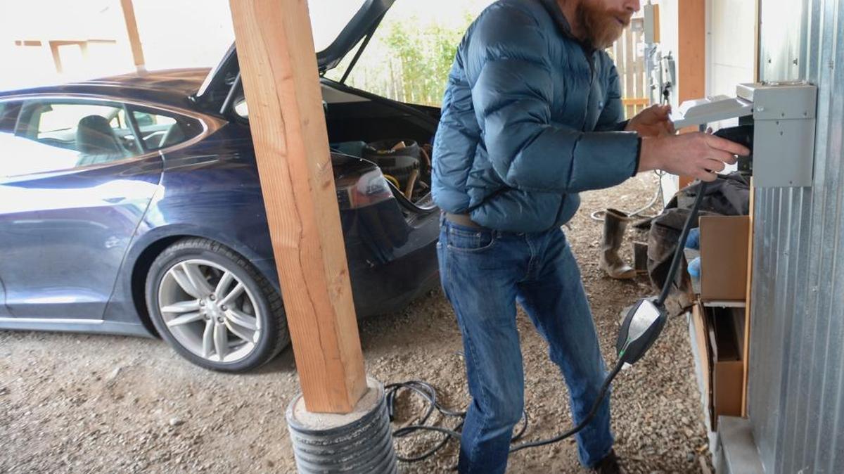 Ted Clifton, shown Wednesday, March 2, 2016, plugs the charger for his Tesla Model S into his solar-powered house in Bellingham.