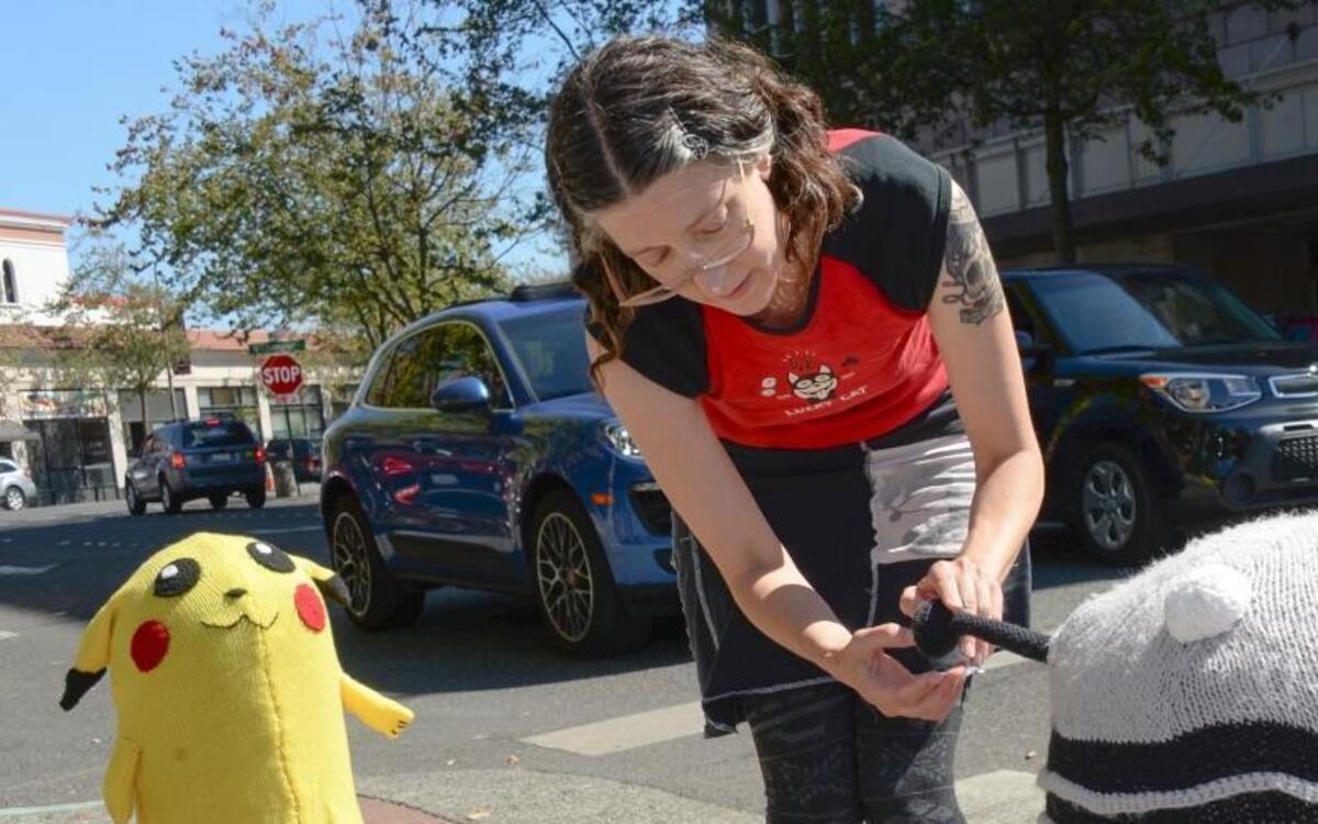 Heather Seevers of NW Handspun Yarns covers a bollard with a knitted Dalek character from the Doctor Who sci-fi TV show outside her store at Commerical and West Magnolia streets in Bellingham, Thursday, Aug 18, 2016. She also made the Pikachu bollard cover in the background.