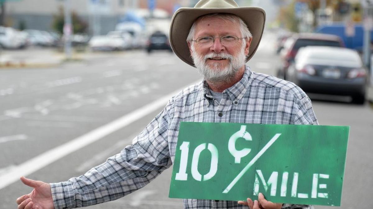 Michael Schneider, a Lummi Island resident, hitchhikes regions of the country with a pay-as-he-rides offer to drivers, Thursday, Sept. 29, 2016, in Bellingham.