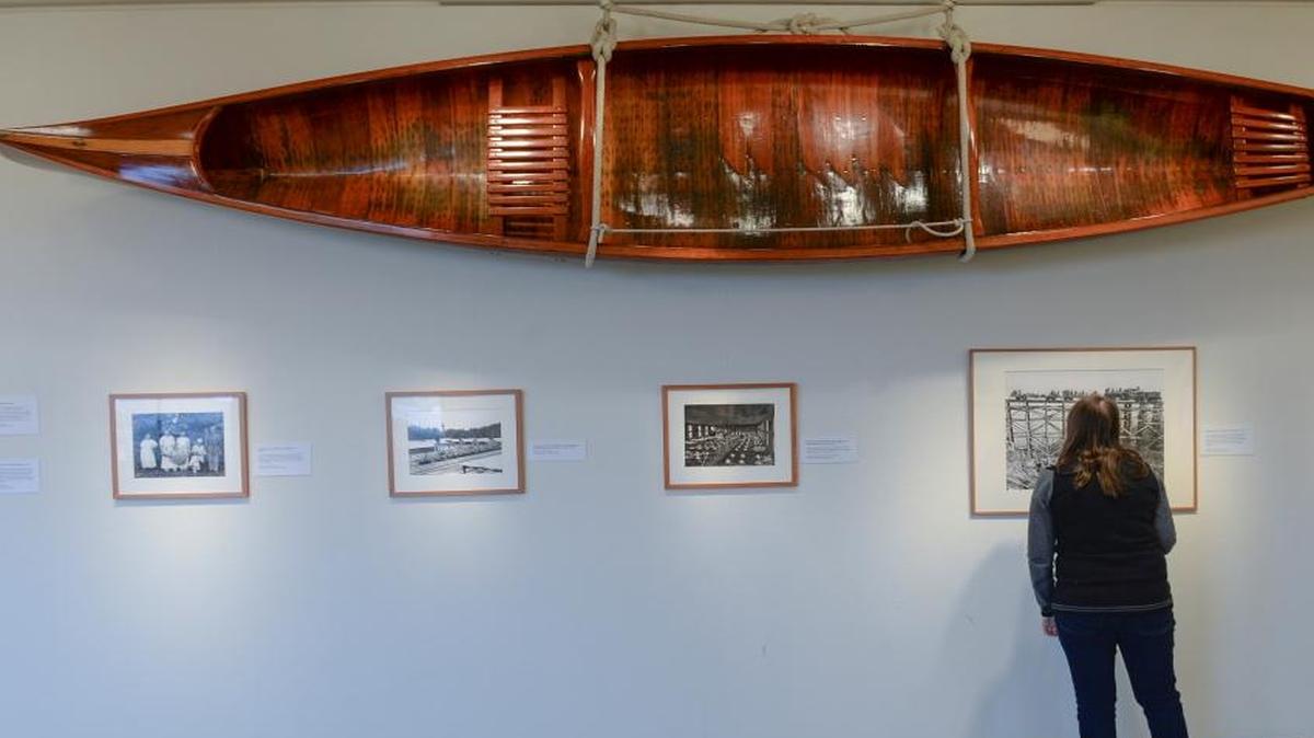 Laura Matusek looks at historic photos by Darius Kinsey at Whatcom Museum’s Old City Hall building on Thursday, Feb. 4, 2016. The canoe was made in 1927 in Tacoma. New history galleries will be installed in the building this year and in 2017.