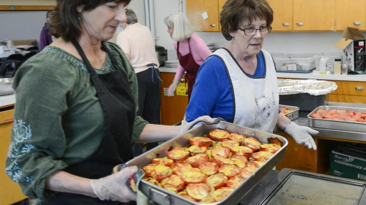 Coordinator Anne Poulson, left, and volunteer Sandie Starr bake tomatoes for lunch at Maple Alley Inn at Faith Lutheran Church in Bellingham on Oct. 14, 2015. The free meal is sponsored by the Opportunity Council on Wednesdays and Thursdays. In 2014, a total of 1,385 people ate hot free meals there.