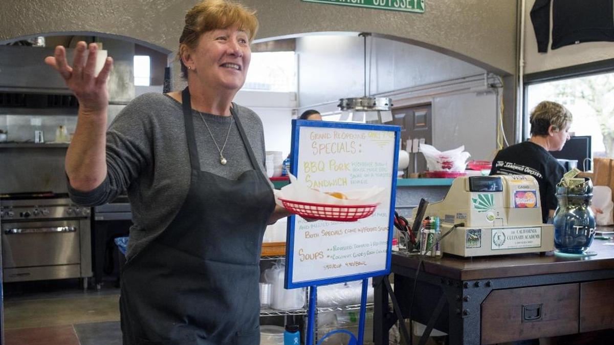 Mirela Giaconi greets a regular customer in the lobby as she brings a sandwich out to another at the grand reopening of Sandwich Odyssey on Wednesday, May 3, in Bellingham. With restaurant remodels and new openings, Whatcom County continues to increase sales in eateries and drinking establishments, according to the latest retail sales data.