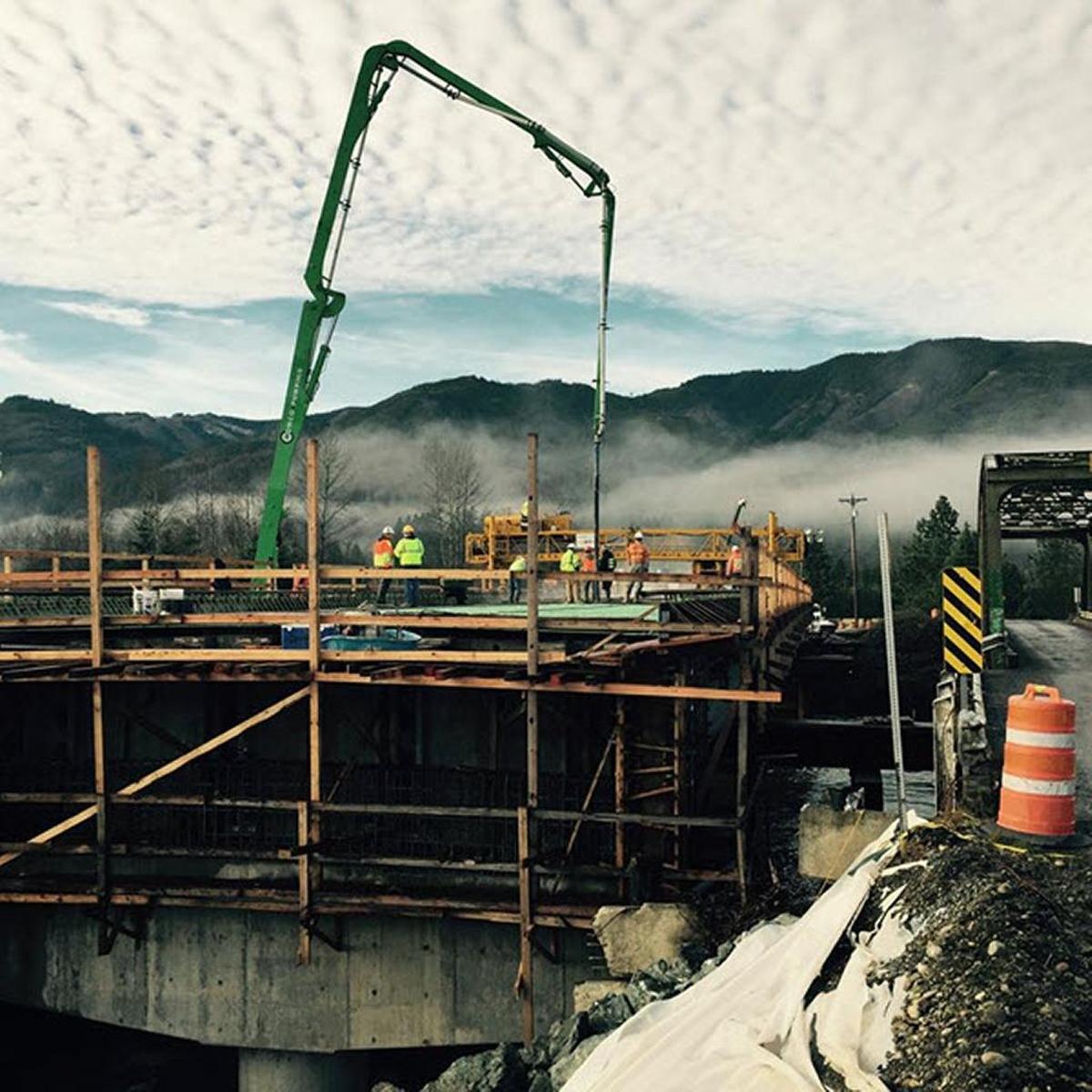 Workers pour concrete for the Potter Road bridge deck.
