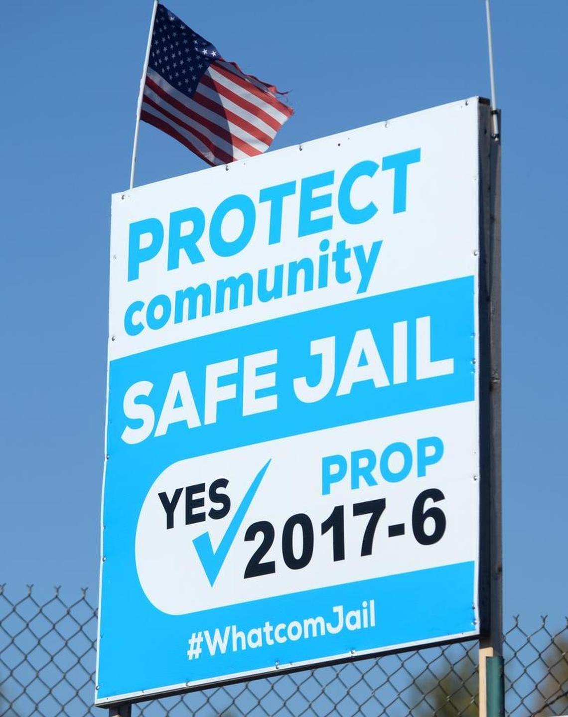 Sign overlooking Interstate 5 near Sunset Drive in Bellingham supporting building a new Whatcom County Jail.