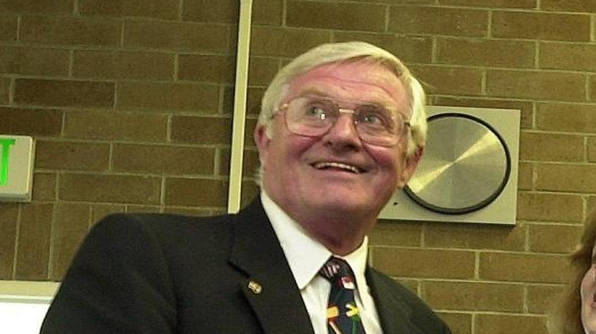 Retiring Bellingham Technical College President, Desmond McArdle, left, and his daughters Joyce Weinand, Patty McGuane and Pauline Black laugh while watching a slide show featuring McArdle’s career on June 29, 2001.