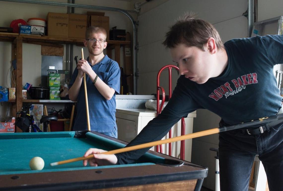 Allen Turner, 24, right, and Ricky Manwill, 27, play pool in the garage of Pine Street Home on Wednesday, May 10, in Lynden. Pine Street is a home operated by Cascade Connections for adults with developmental disabilities.