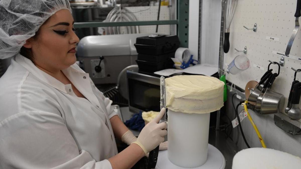 Devin Rodriguez frosts a red velvet cheesecake at Chuckanut Bay Foods in Ferndale on Wednesday, March 2, 2016. The company is building a new facility.