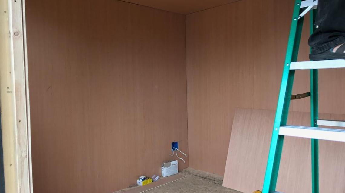 Volunteers worked most of the day Saturday to place electrical wiring, siding and vinyl flooring in the home.