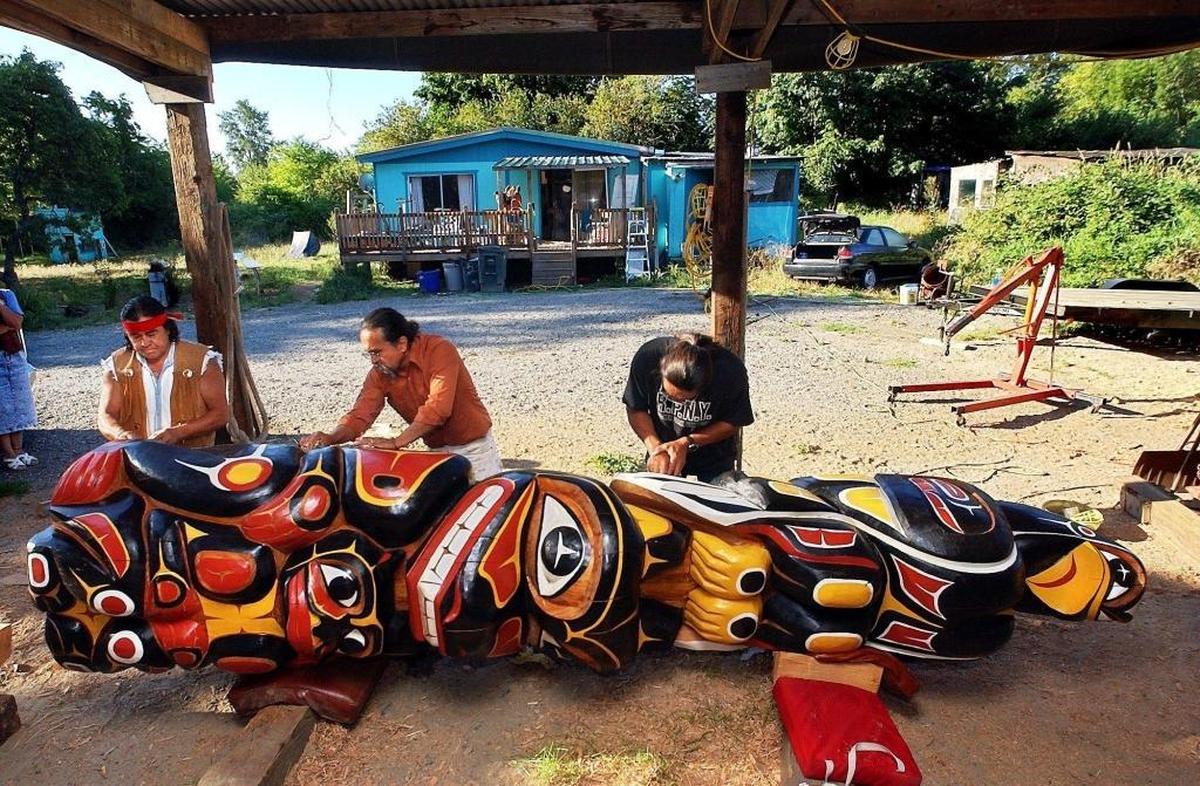 House of Tears carvers Doug James, left, Jewell James and Charles Miller work on the Healing Pole in 2002. House of Tears created the totem as an act of healing after the Sept. 11, 2001 terror attacks. It sits in the Sterling Forest in New York, an hour’s drive from Ground Zero.