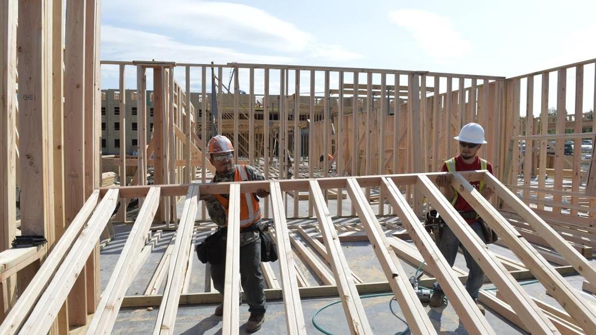 Workers put up a wall at a construction site in Bellingham in this April 2015 file photo. Public meetings are scheduled Tuesday and Aug. 9 to talk about two large residential projects.