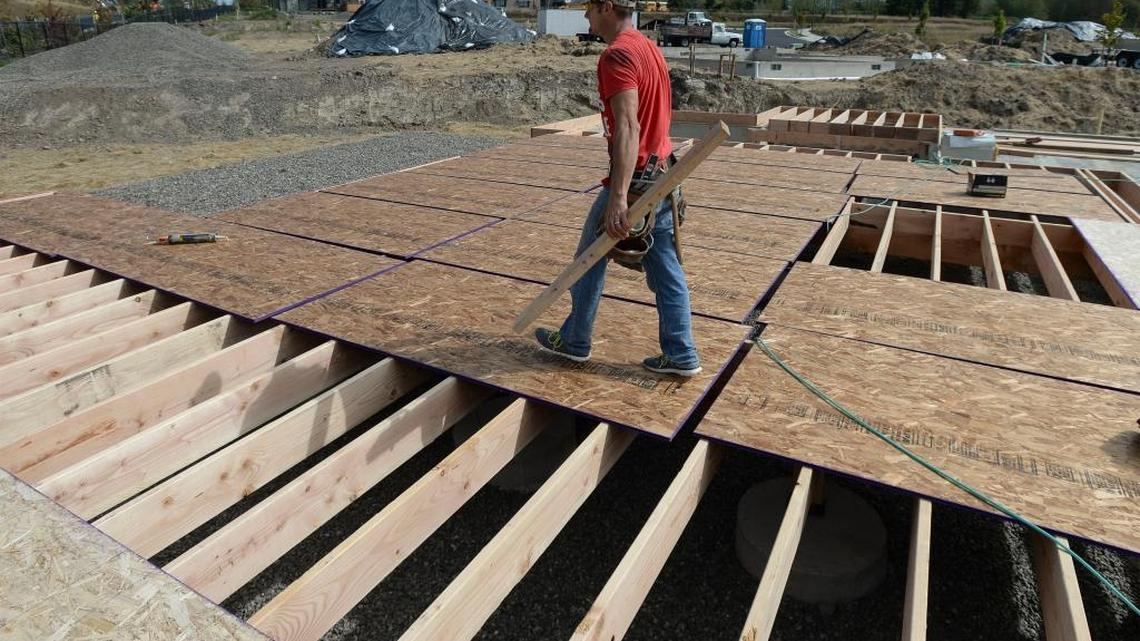 Framer Vladimir Chernomorets works on a home under construction at The Meadows, a development off Thornton Road in Ferndale on Friday, Sept. 9, 2016.
