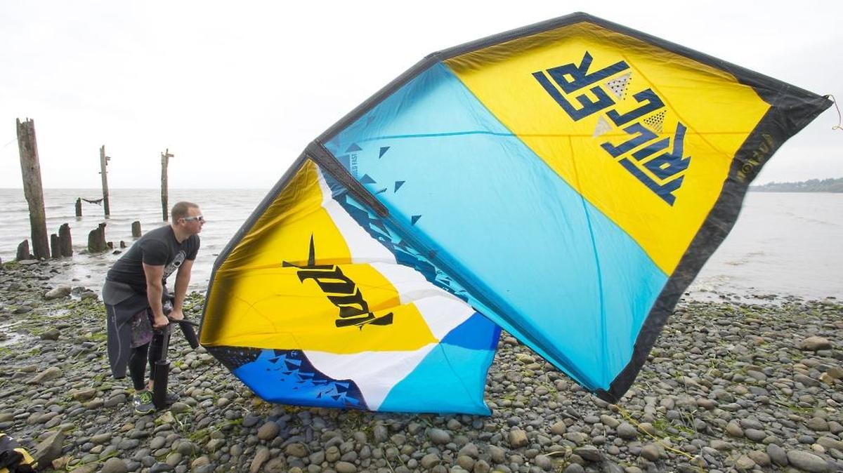 Joel Townsan of Bellingham pumps up his kite before going kiteboarding at Locust Beach on Bellingham Bay on Oct. 2, 2015.
