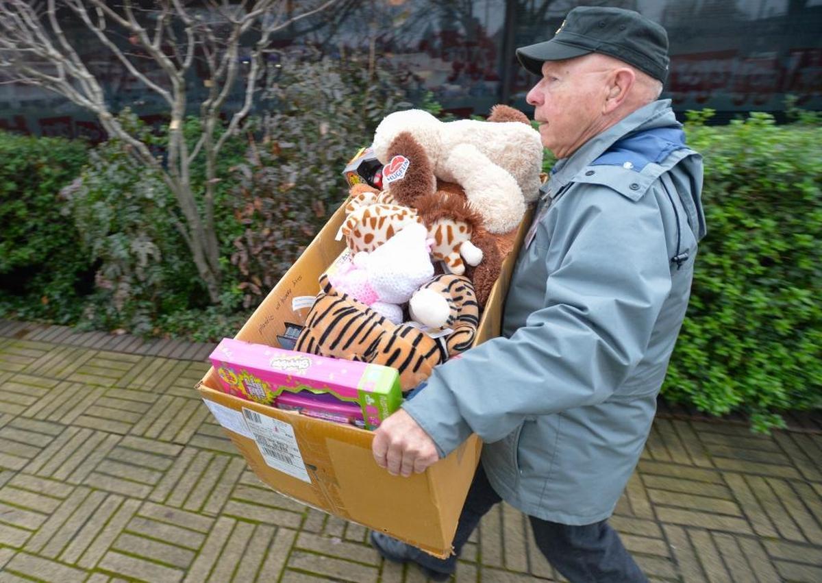 Volunteer and veteran John Forgette of Bellingham unloads toys at the Toys for Tots distribution center at 315 Lakeway Drive across from the Chevron station in Bellingham on Tuesday Dec. 8, 2015. The distribution center is open the next two Fridays and Saturdays from 9 a.m to 5 p.m.