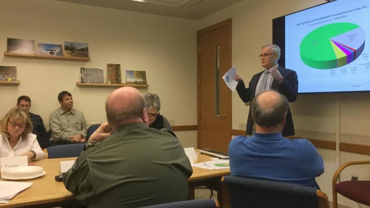 Whatcom County Executive Jack Louws, right, lays out a possible plan to divide and spend the revenue from a yet-to-be-approved sales tax that would be used to pay for a new Whatcom County jail. Louws spoke during a meeting of the Jail Stakeholder Workgroup on Friday.