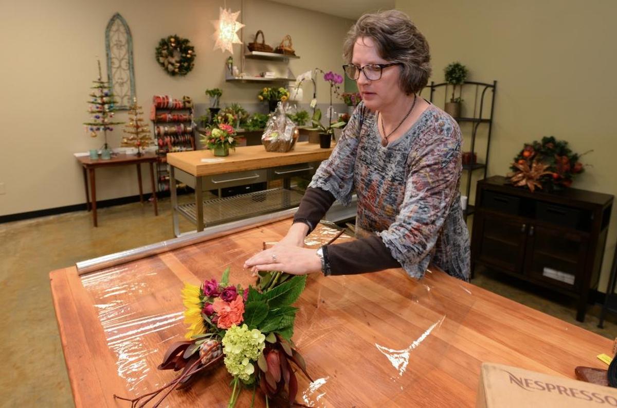 Owner Kristin Noble Baker makes a flower arrangement at Checkered Lily Flowers & Gifts, her new store at 4151 Meridian Street, Suite 116 in Bellingham, Tuesday, Nov 28, 2017.