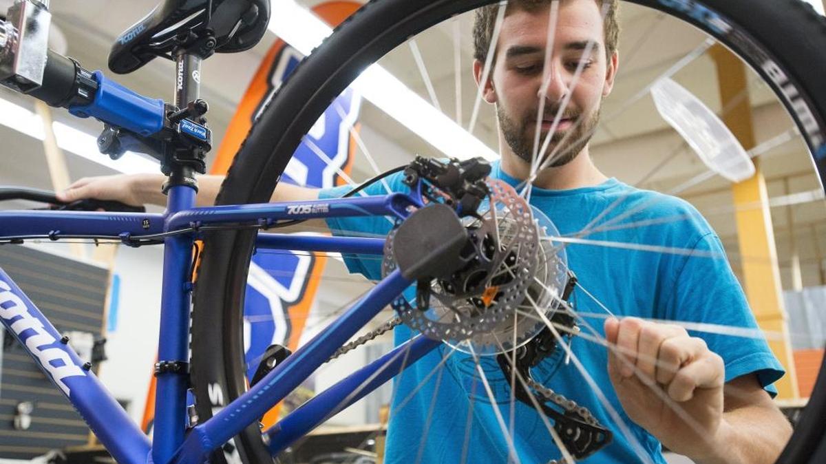Mark Allison prepares a new bicycle to go on the showroom floor at Kona Bicycle Co. on North State Street. Kona is one of the exhibitors at the Recreation Northwest Expo on Friday, Feb. 26.